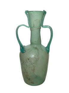 A large Roman glass two-handled bottle: A large Roman glass two-handled bottle, c. 2nd - 3rd Century AD, the body nearly cylindrical with deeply indented base, the neck narrow with flared mouth and outward rolled rim, a large handle at