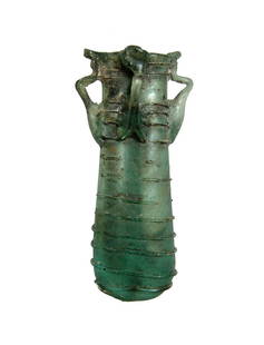 Choice Roman dark green glass double unguentarium: A choice Roman dark green glass double unguentarium, c. 4th - 5th Century AD, with four handles and threading around body. Very well-preserved with light deposits. H: 3 3/4 in (9.6cm). Ex Brauns