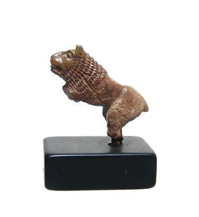 A beautifully carved Roman bone figure of a lion: A beautifully carved Roman bone figure of a lion, c. 1st - 3rd Century AD, in naturalistic style with crisp details. Perhaps from a hair pin or other decorative item. 2.7 x 2.4 cm. Nice tannish