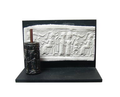 A nice Near Eastern black steatite cylinder seal: A nice Near Eastern black steatite cylinder seal, 2nd Millennium BC, depicting a richly adorned figure presenting offering to a seated deity or king, a small figure between them. Nicely detailed and