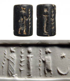 A Near Eastern black steatite cylinder seal: A Near Eastern black steatite cylinder seal, 2nd Millennium BC, depicting two standing figures, to left, a woman wearing a long gown holding a palm frond, to far right a standing male wearing a cowl