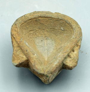 A nice Gandharan stone oil lamp: A nice Gandharan stone oil lamp, Indus Valley, c. 3rd - 4th Century AD, nicely detailed and carved from the gray schist characteristic of the area. It is decorated with triangular flanges on the