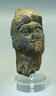 A nice Gandharan stone head: A large Gandharan stone head, Indus Valley, c. 3rd - 4th Century AD. This fine fragment is 3 in (7.6 cm) high and is carved from the blue-gray schist characteristic of the region. It depicts a man