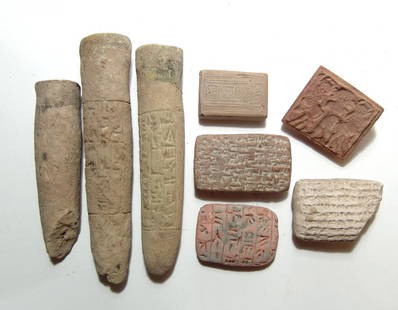 A group of 8 replica Mesopotamian terracotta items: A group of 8 replica Mesopotamian terracotta items. Lot includes 3 replica cuneiform clay tablets, 3 replica cones with cuneiform inscriptions, and a pair of replica seals. Largest 6 in (15.2 cm).