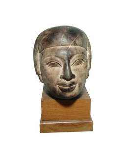 Large and attractive Egyptian stone head replica: A large and attractive Egyptian stone head replica on base. Carved in stone, perhaps limestone, with attractive features and mounted on a nice wood base. 7 1/4 x 7 in (18.4 x 17.8 cm).