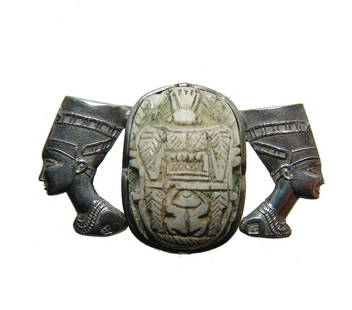 A beautiful scarab brooch in ancient Egyptian style: A beautiful scarab brooch in ancient Egyptian style. Of modern manufacture, the silver brooch showcases a wonderfully carved steatite scarab flanked with the heads of the famous bust Queen Nefertiti.