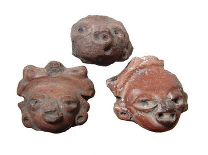 Group of 3 attractive Pre-Columbian ceramic heads: A group of 3 attractive Pre-Columbian ceramic heads each slipped in a deep-red orange and with collection numbers inked on back. Largest 2 5/8 x 2 1/2 in (6.7 x 6.3 cm). Ex Philadelphia private