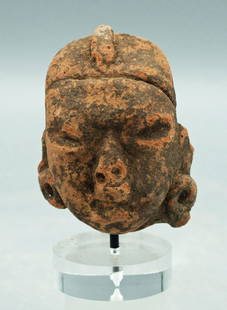 A nice Olmec head from Mexico: An excellent Olmec head from Mexico, c. 1200 - 200 BC, depicting an individual wearing a headdress and large ear spools. H: 2 5/8 in (6.7 cm). Strong mineral deposits. Mounted. Ex St. Paul private