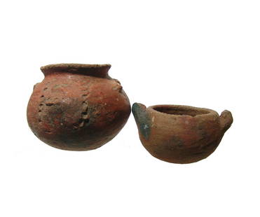 A pair of Costa Rican pottery vessels: A pair of Costa Rican pottery vessels, c. AD 1000 - 1450, one with some decoration in relief and the other with a pair of small handles. 3 x 31/2 in (7.6 x 8.9 cm) & 1 1/4 x 3 1/4 in (3.2 x 8.3 cm).