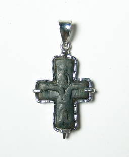 Byzantine bronze cross set into a custom silver pendant: A byzantine bronze cross set into a custom silver pendant. The bronze cross, c. 10th - 12th Century AD, is the front half of an enkolpia bearing the image of the Virgin with arms outstretched. The