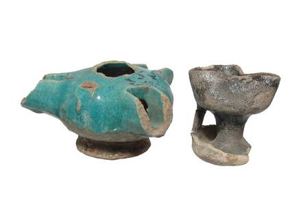 A pair of Islamic turquoise-glazed lamps: A pair of Islamic turquoise-glazed lamps, c. 12th - 13th Century AD, the first on a pedestal base with trefoil pinched mouth, 2 3/4 x 2 3/4 in (7 x 7 cm), the second a triple-spouted lamp with