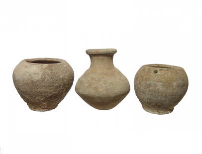 A lot of 3 Roman ceramic vessels, Holy Land: A lot of 3 Roman ceramic vessels, Holy Land, c. 1st - 4th Century AD, including two small jars and a bottle, each with earthen and mineral deposits. Largest 2 7/8 in (7.3 cm) in height. Ex Gagne