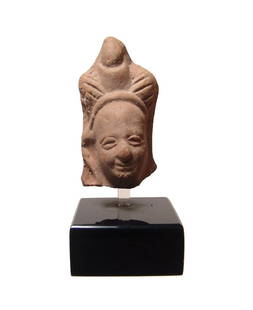 A Romano-Egyptian terracotta head of Harpokrates: A Romano-Egyptian terracotta head of Harpokrates, 1st - 2nd Century AD, with side-lock and wearing the Double Crown of Upper and Lower Egypt flanked by feathers. His features are well-modeled in fine