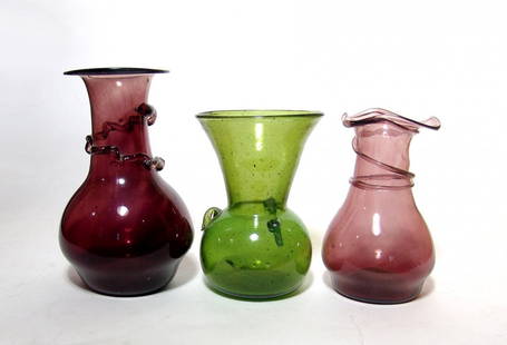 A lot of three attractive antique glass bottles: A lot of three attractive antique glass bottles, c. early 20th Century, each beautifully blown in an attractive shape inspired by Roman glass types, the colors vivid. From 6 in (15.2 cm) to 7 ¼ in