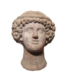 A fabulous Etruscan terracotta head of a young woman: A fabulous Etruscan terracotta head of a young woman, c. 3th - 3rd Century BC, her youthful features wonderfully modeled, her hair in a mass of tight curls below a narrow diadem with central rosette