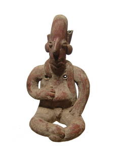 An attractive Jalisco figure of a seated man: An attractive Jalisco figure of a seated man, West Mexico, c. 200 BC - AD 350, hand-modeled with elongated head and prominent nose. He wears large ear ornaments with wrapped fabric around his