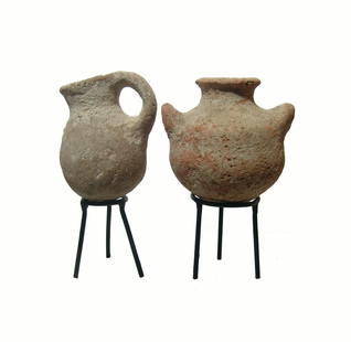 A pair of Iron Age vessels from the Holy Land: A pair of Iron Age vessels from the Holy Land, c. 1200 - 800 BC, the first is a juglet, with rounded body, loop handle and lightly pinched spout, H: 3 1/4 in (8.3 cm). The second vessel is a pyxis