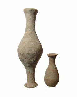 A pair of Roman ceramic bottles: A pair of Roman ceramic bottles, c. 1st Century AD, the first is a large spindle bottle with wide foot and tall neck, L: 7 1/8 in (18.1 cm). The second is a nice unguent bottle with ovoid body and