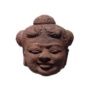 Beautiful Majapahit terracotta woman's head, East Java: A beautiful Majapahit terracotta head of a woman, East Java, c. 14th Century, extremely well-modeled in fine style with detailed features and wearing earrings, her hair styled into four buns, one on