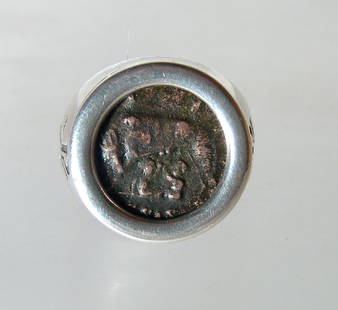 A lovely silver ring with a Roman bronze follis: A lovely silver ring with a Roman bronze follis. The coin was struck under Constantine I 'the Great', AD 207 - 337, and it features the bust of Roma on one side and the famous She-Wolf suckling the