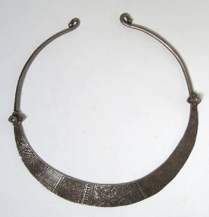 A lovely Ottoman silver torc, 16th - 17th Century: A lovely Ottoman silver torc, 16th - 17th Century, the frontal area hammered flat and decorated with an incised geometric band, a floral element at each end, and the back portion of heavy wire with