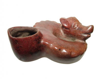 A cute Colima coiled dog, West Mexico: A cute Colima coiled dog, West Mexico, c. 100 BC - AD 200, the body stylized with detailed head and open spout opposite. The piece is very well preserved with beautiful glossy red burnished surfaces