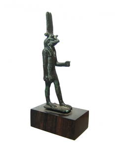 Rare and fascinating Egyptian bronze figurine of Montu: A very rare and fascinating Egyptian bronze figurine of the god Montu, Late Period, c. 664 - 332 BC, the falcon-headed god of war, depicted with the horns of a bull, wearing a short striated kilt and