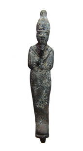 An Egyptian bronze figure of Osiris, Late Period: An Egyptian bronze figure of Osiris, Late Period, c. 664 - 332 BC, mummiform, wearing Atef crown with uraeus and false beard, arms folded at chest and holding a crook and flail. 5 3/8 in (13.7 cm).