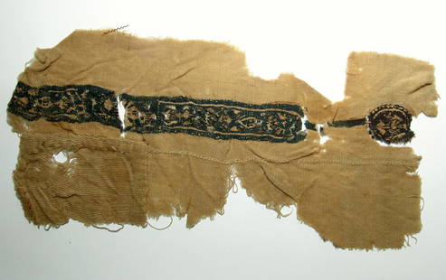 A large Coptic textile panel, Egypt: A large Coptic textile panel, Egypt, c. 5th - 7th Century AD, the creme colored linen panel featuring a decorative band containing stylized floral elements, a medallion at one end. An interesting piec