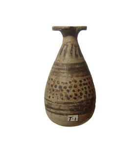 An Etrusco-Corinthian aryballos: An Etrusco-Corinthian aryballos, c. 6th Century BC, the ovoid body decorated with horizontal bands and dots in dark brown slip, vertical tongues around the shoulders. H: 3 1/4 in (8.3 cm). Surface