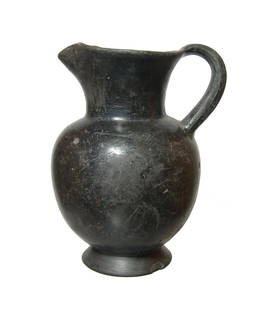 An Etruscan Bucchero oinochoe with trefoil spout: An Etruscan Bucchero oinochoe, 600 - 550 BC, the body ovoid with flared foot, short neck with trefoil pouring spout and single handle. The surface retains their glossy burnish surface with light