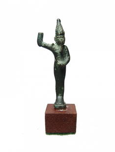 Egyptian bronze amulet of the god Min, Late Period: An Egyptian bronze amulet of the god Min, Late Period, c. 664 - 332 BC, who represented the masculine principle and was a god of fertility and the harvest. He is depicted standing on integral base,