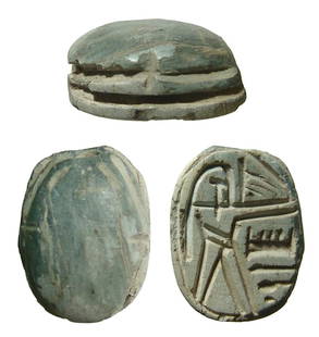 An Egyptian steatite scarab: An Egyptian steatite scarab, later 2nd Intermediate Period - early 18th Dynasty, c. 1630 - 1500 BC, the body is worn with grooves for legs, on base, a human-headed figure stands with arm extended