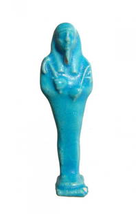 A vibrant blue Egyptian faience ushabti, Late Period: A vibrant blue Egyptian faience ushabti, Late Period, 30th Dynasty - Ptolemaic, c. 380 - 30 BC, mummiform, wearing tripartite wig and false beard, arms folded across chest, hands holding a pick and