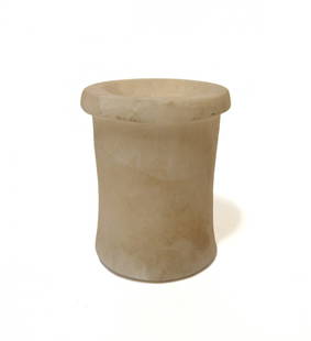 An Egyptian alabaster vessel, Middle Kingdom: An Egyptian alabaster vessel, Middle Kingdom, c. 2050 - 1710 BC, of heavy construction, the bottom slightly flared and with a wide rim; the interior is partially drilled. 2 5/8 x 2 1/4 in (6.7 x 5.7