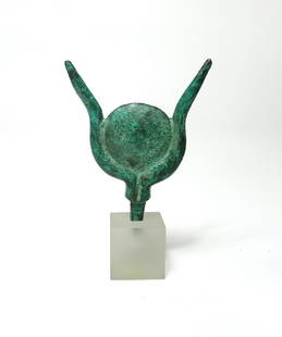 Egyptian bronze headdress in the form of a sun disk: An Egyptian bronze headdress in the form of a sun disk set between a pair of bull's horns, Late Period, c. 664 - 332 BC, likely from a figure of the goddess Hathor. The piece is well-preserved with