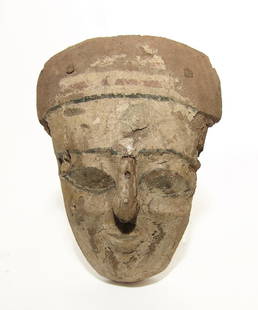 An Egyptian painted wood 'mummy' mask, Late Period: An Egyptian painted wood 'mummy' mask, Late Period, c. 664 - 332 BC, from an anthropoid sarcophagus lid, carved from a single piece of wood except the nose which had to be added with small dowel. The