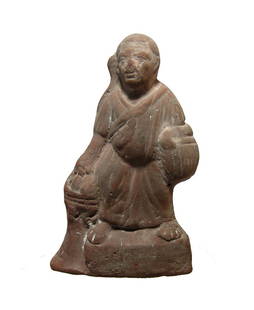 A Roman terracotta figure of Harpokrates, Egypt: A Roman terracotta figure of Harpokrates, Egypt, c. 1st - 2nd Century AD, in the guise of an old man, wearing robes and characteristic side-lock, carrying a basket on one arm and grasping fruit from
