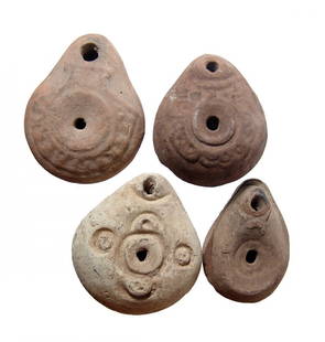 A lot of 4 Romano-Egyptian ceramic frog lamps: A lot of 4 Romano-Egyptian ceramic 'frog' lamps, c. 6th - 7th Century AD, each lentoid, with concave border around fill-hole. The shoulder of three are decorated with geometric designs and one with