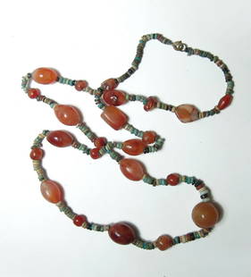 A gorgeous Egyptian faience and agate beaded necklace: A gorgeous Egyptian faience and agate beaded necklace. The multicolored faience disc beads are from the Late Period, c. 664 - 332 BC, and are well-preserved. They are strung with round and ovoid agate