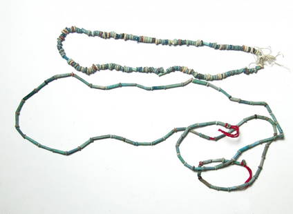 A lot of two strands of Egyptian faience beads: A lot of two strands of Egyptian faience beads, Late Period - Ptolemaic, c. 664 - 30 BC, the first comprised of mainly light to pale blue faience tubular beads interspersed with creme colored disc bea