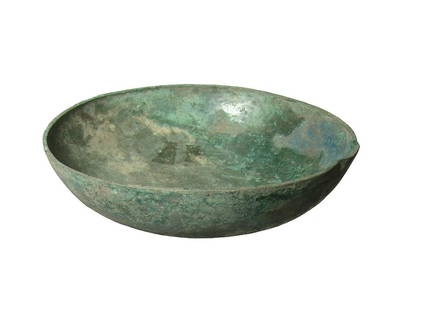 A well-preserved Near Eastern bronze bowl: A well-preserved Near Eastern bronze bowl, c. 1000 - 600 BC, fashioned from bronze sheet with flattened rim. Dia: 6 in (15.2 cm). Nicely patinated, a few tiny corrosion holes. Ex West Virginia