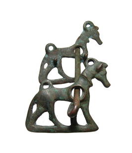 A choice Near Eastern bronze horse bit: A choice Near Eastern bronze horse bit, c. 1000 - 800 BC, the cheek pieces in the form of horses. The mouthpiece is rigid with hammered ends, the check pieces are cast with loops for attachment of