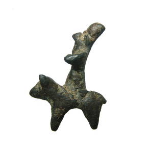 A Near Eastern bronze votive horse and rider: A Near Eastern bronze votive horse and rider, c. 1000 - 600, the rider with large angular nose, short, tapered arms and wears a domed Persian style hat. He sits on the back of a bull, fore and hind