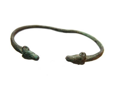 A nice little Near Eastern bronze bracelet: A nice little Near Eastern bronze bracelet, c. 1000 - 600 BC, terminating with a pair of extremely well-detailed ram's heads. 2 5/8 x 2 cm. (6.7 x 5 cm). Ex Detroit private collection.