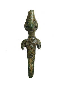 A Canaanite bronze votive figure: A Canaanite bronze votive figure, c. 1700 - 1500 BC, stylized with conical headdress, large eyes, angular nose, large ears pierced for earrings, vestigial arms and body tapering to a peg below the