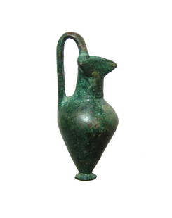 A well-preserved Greek bronze votive trefoil olpe: A well-preserved Greek bronze votive trefoil olpe, 6th - 5th Century BC, with looped handle and attractive mottled green patina. H: 2 1/4 in (5.7 cm). Ex collection of William Ashby.