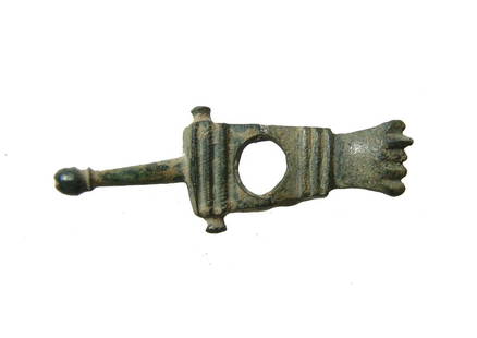 A Roman bronze phallic applique: A Roman bronze phallic applique, c. 1st - 3rd Century AD, perhaps part of a buckle, the central portion with raised lines and large hole, the two knobs on the sides where the piece was attached to a