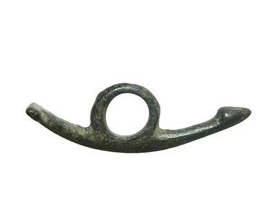 A Roman bronze phallic amulet: A Roman bronze phallic amulet, 1st - 3rd Century AD, the slender form slightly curved with large circular suspension loop. L: 1 5/8 in (4.2 cm). Nicely patinated. Ex Swiss private collection.