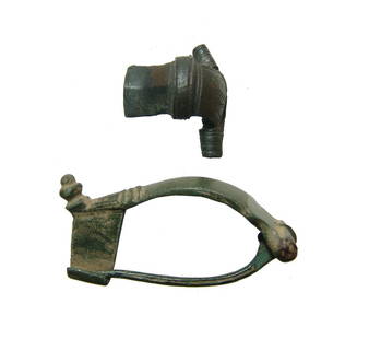 A pair of Roman bronze brooches: A pair of Roman bronze brooches, 1st - 2nd Century AD, an include a Kraftig profilierte type and a knee brooch. Both are well-preserved with original pin and catch. L: 2 3/8 in (6 cm) & 1 1/16 & 1